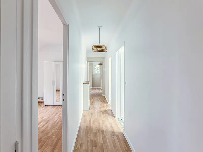 Luminaire suspendu dans un couloir rénové, éclairage général uniforme pour une circulation sécurisée